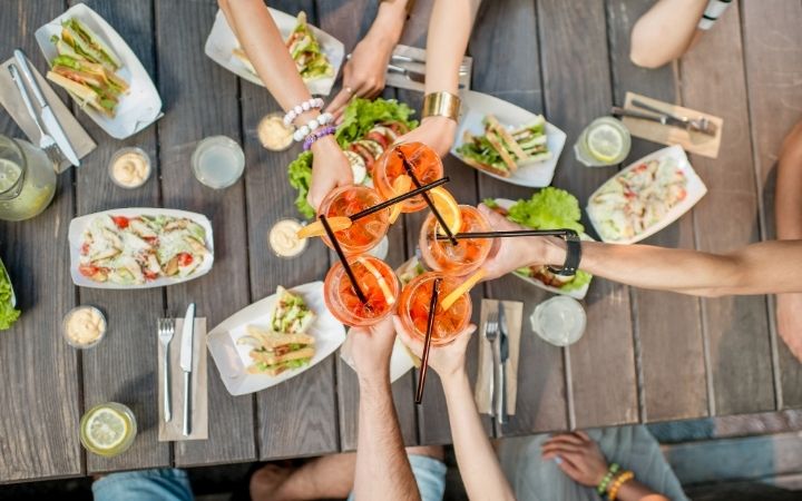 Table full of snacks and drinks, Italian Aperitivo – What is it and how to enjoy it - The Proud Italian