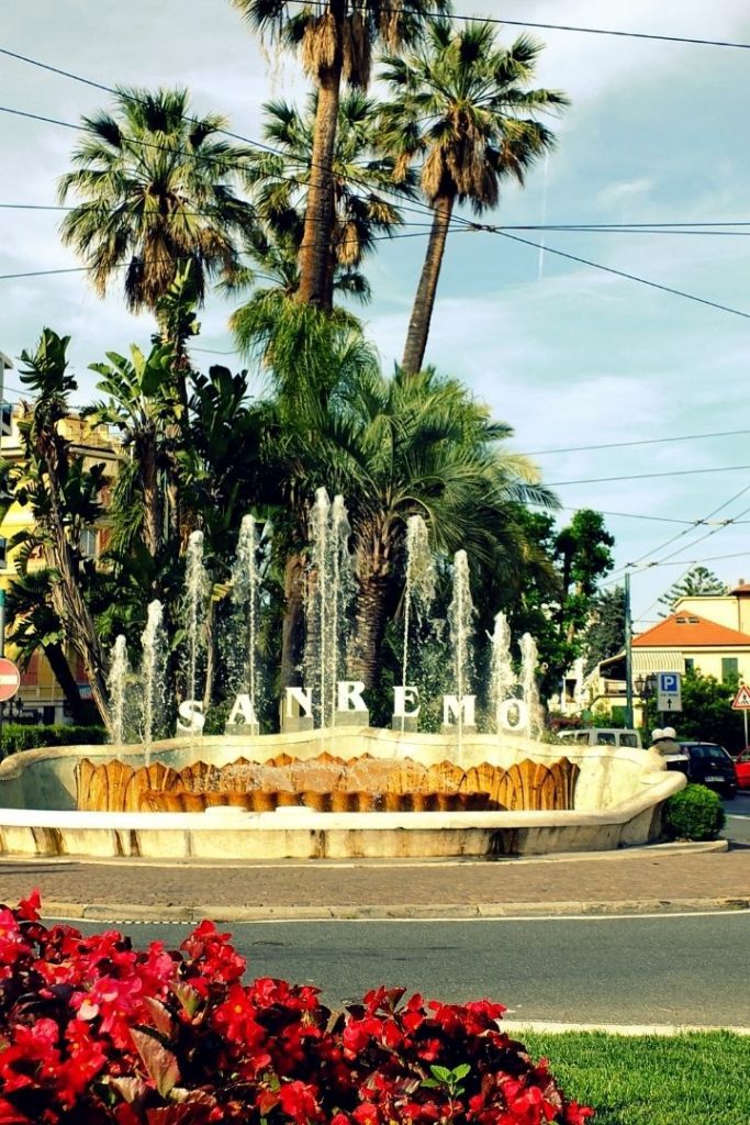 San Remo fountain with written Sanremo, flowers and palm trees - The Proud Italian