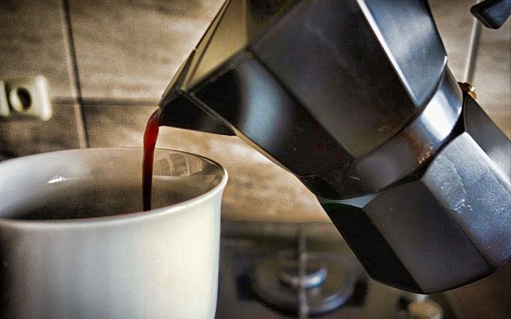 Pouring coffee from coffee pot - The Proud Italian
