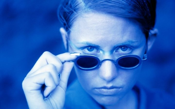 woman staring over sunglasses