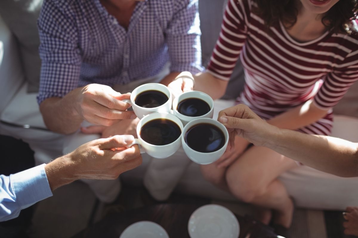 Friend toasting coffee cups together