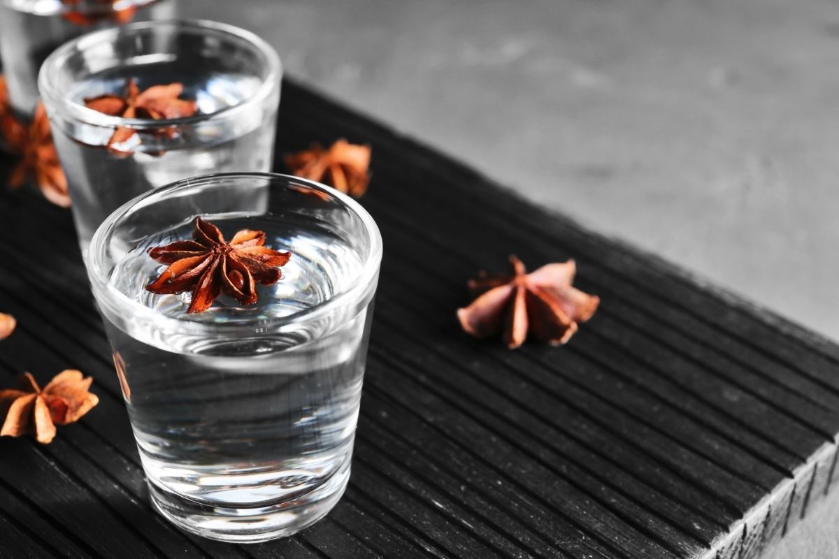 Vodka with Anise on Wooden Board Closeup
