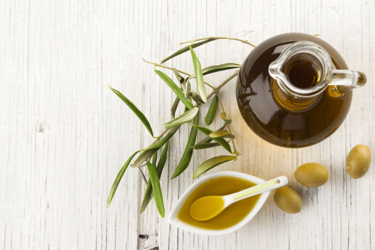 Olive oil on wooden background