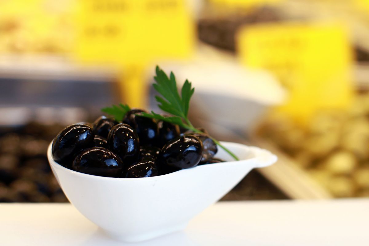 Black olives in white bowl