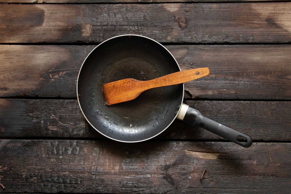 Frying pan on old wooden table